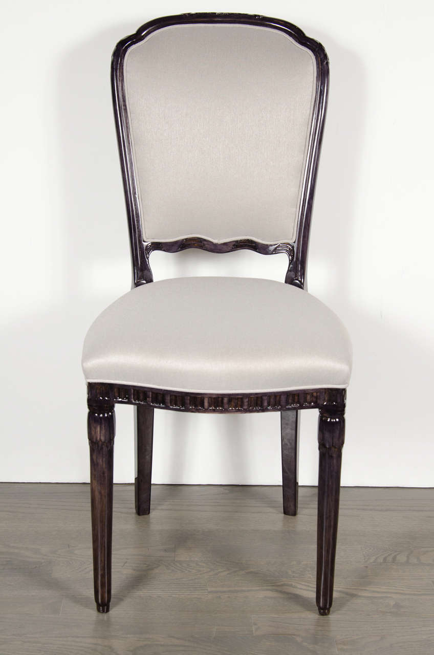 This elegant Art Deco side chair in the manner of Emile-Jacques Ruhlmann features an ebonized walnut frame and platinum sharkskin upholstery. The frame has tapered conical legs with subtle markings and detail across the seat front and a fan-back