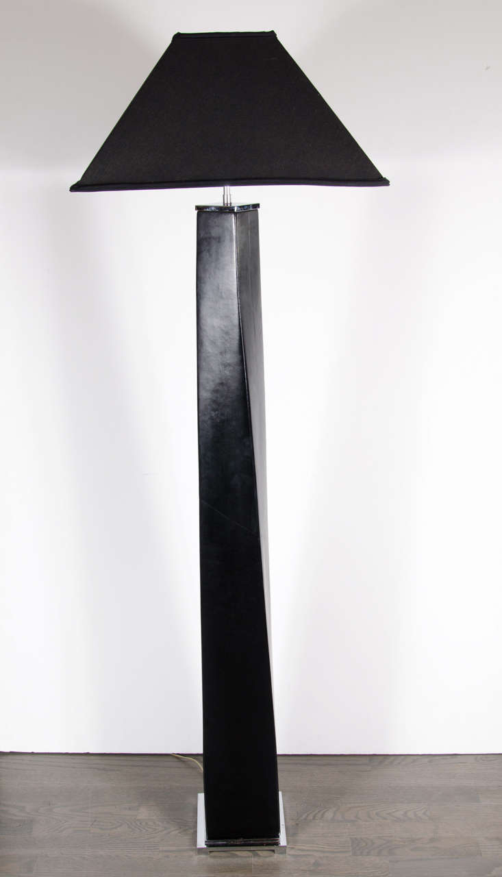 Ultra-chic black leather wrapped columnar floor lamp in the manner of  Karl Springer featuring a slight twist design on a chrome platform base, a custom styled pagoda shade and chrome fittings.  Newly rewired.