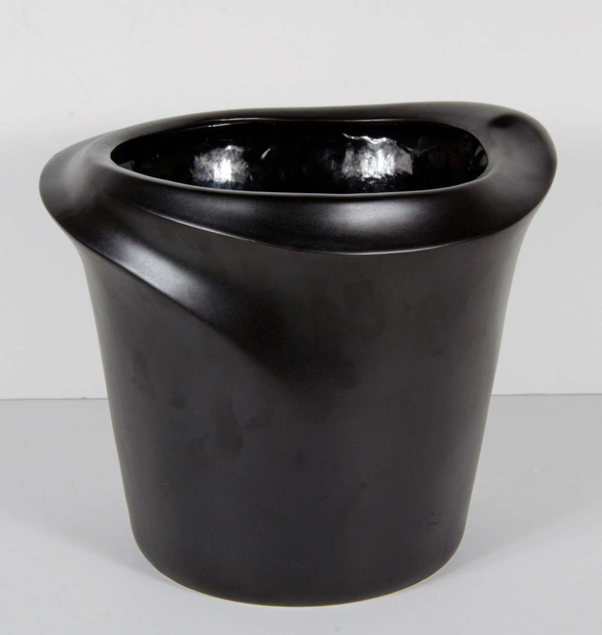 This ultra chic bucket/cooler is designed by the noted Elsa Peretti for Tiffany & Co . It has an organic and naturalistic design and is made of matte finished black ceramic.It bears the signature of Elsa Peretti for Tiffany and Co.This would also