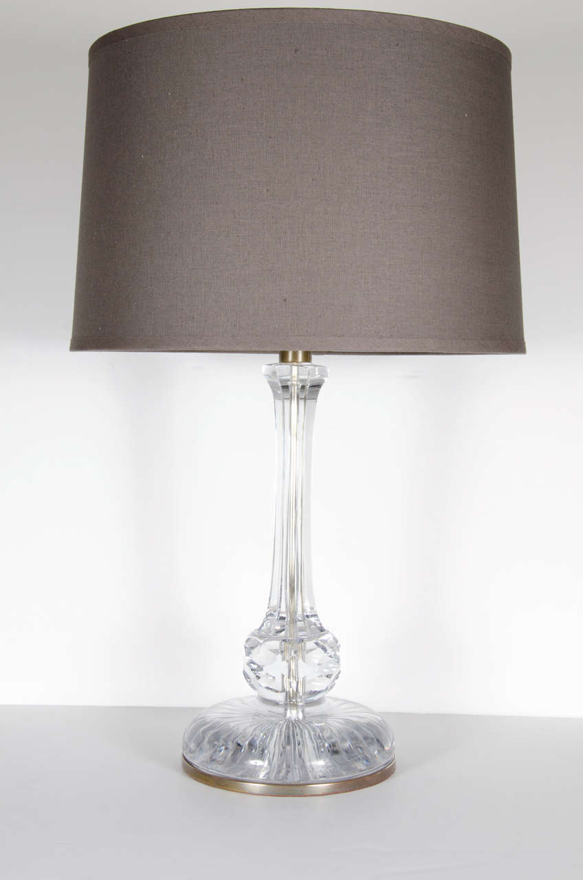 This exquisite Art Deco table lamp by Baccarat features a well proportioned base for stability adorned with a spherical detail extending to a fluted stem. It has antique brass fittings and details, two bulbs & pull chains. Newly rewired Includes new