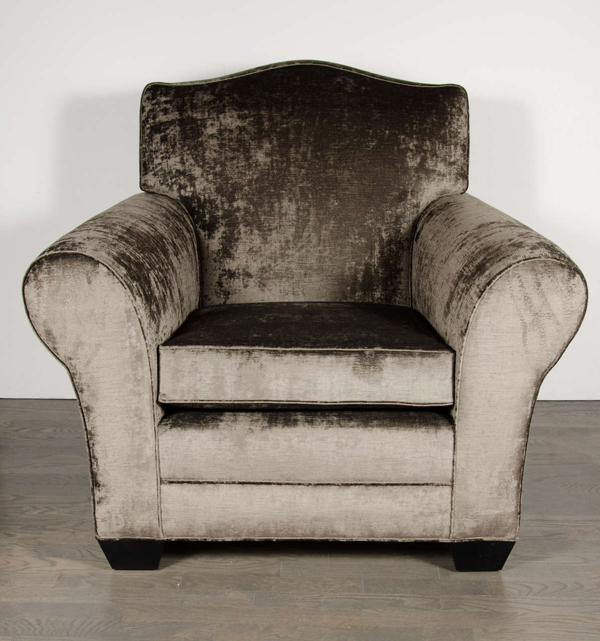 This gorgeous Art Deco French club chair newly upholstered in smoked pewter gauffrage velvet & ebonized walnut legs. It features generous rolled arms, a shield back design and a deep seat you can really sink into. Completely restored to mint
