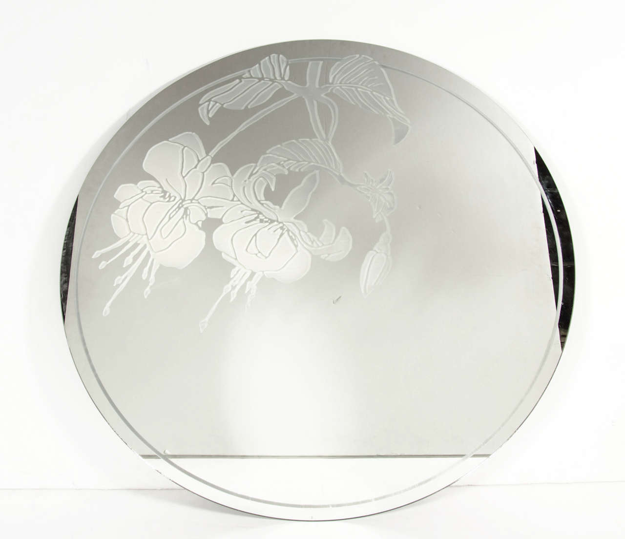 This gorgeous Mid Century Modernist circular mirror features a frosted floral motif as well as a fine line border around the perimeter. The mirror has a hanging plate on the back which allows the mirror to be hung flush to the wall.

American, Circa