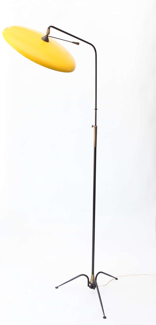 Truly unique two-tone floor lamp, adjustable with handle.  Full extended height is 76 inches.  Yellow lacquered metal shade is 17 inches diameter.
