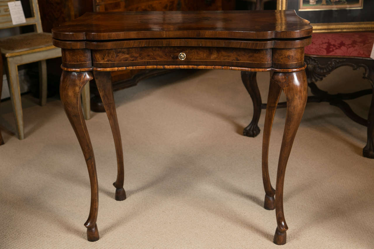 An 18th century Italian Modena (Emilia-Romagna) card table.

Walnut and burl walnut veneered and Inlaid with many different kinds of wood, 
mid-1700.

Similar examples of this card table are published on the Graziano Manni, Mobili Antichi in