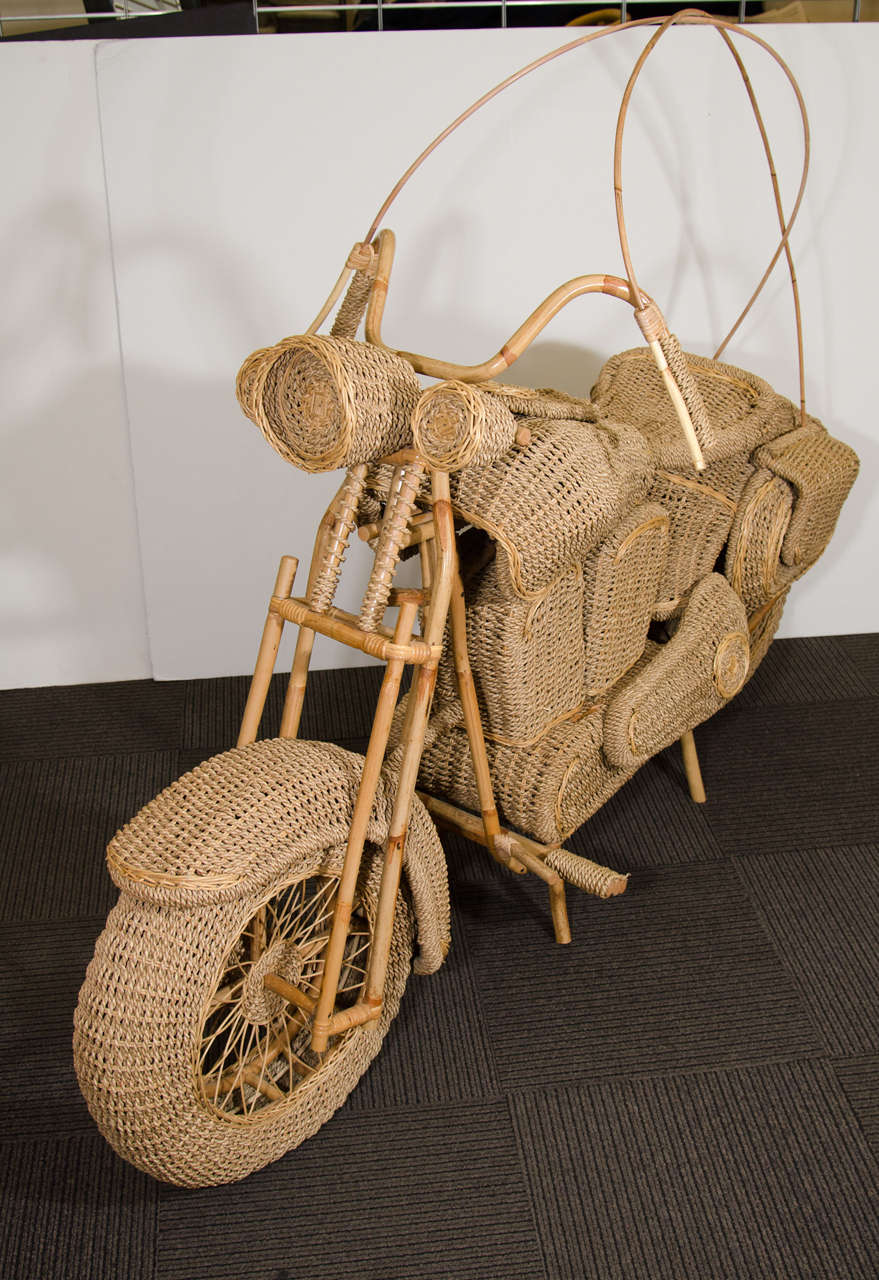A vintage wicker replica of a full-size Harley Davidson motorcycle complete with bamboo accents in the shape of handlebars, brake lines, and gas pedal.

Good vintage condition with age appropriate wear. Some unraveling of pedal.