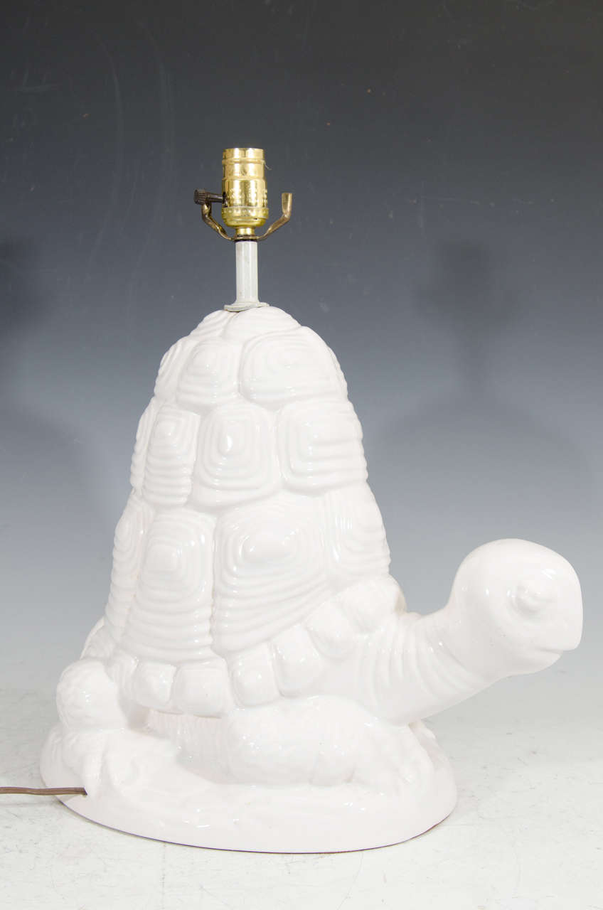 A vintage white sculptural turtle table lamp.

Good vintage condition with a small chip to base.