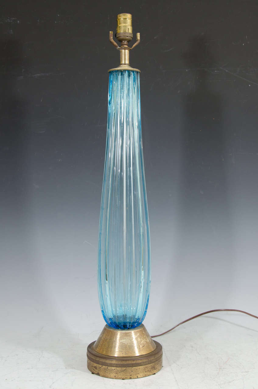A vintage tall blue Murano glass table lamp on brass base.

Good vintage condition with age appropriate wear and patina. Some scratches to the glass and discoloration to brass.
