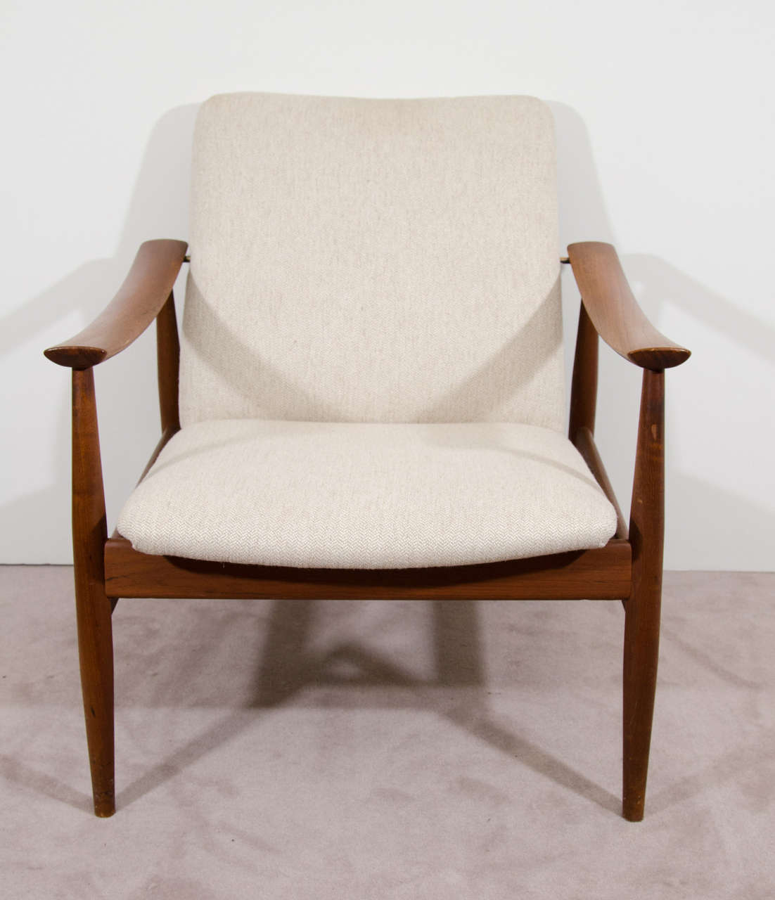 A vintage teak lounge chair by Finn Juhl for France and Sons. Retains its original France and Sons label and John Stuart label. Good vintage condition with age appropriate wear. Some scuff marks to the wood.