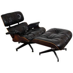 Midcentury Classic Eames Rosewood Chair and Ottoman in Black Leather Upholstery
