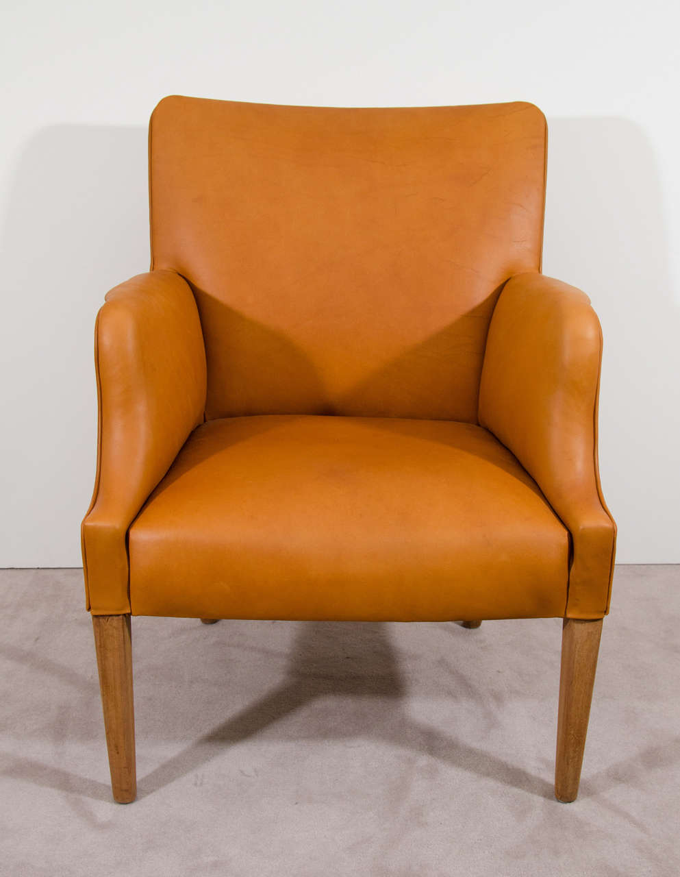 A Danish modern easy chair with mahogany legs and new aniline leather upholstery.