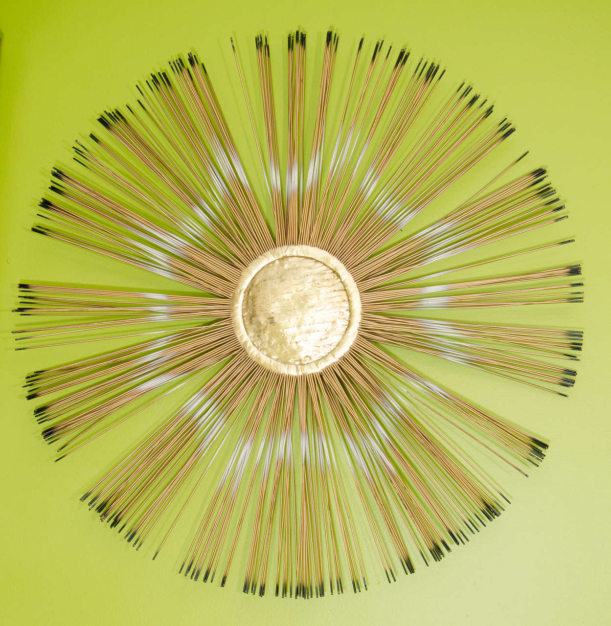 A vintage copper sunburst wall sculpture inspired by Curtis Jere.