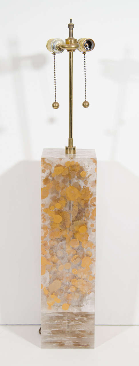 A vintage solid Lucite table lamp with gold inclusion by Romeo Paris.