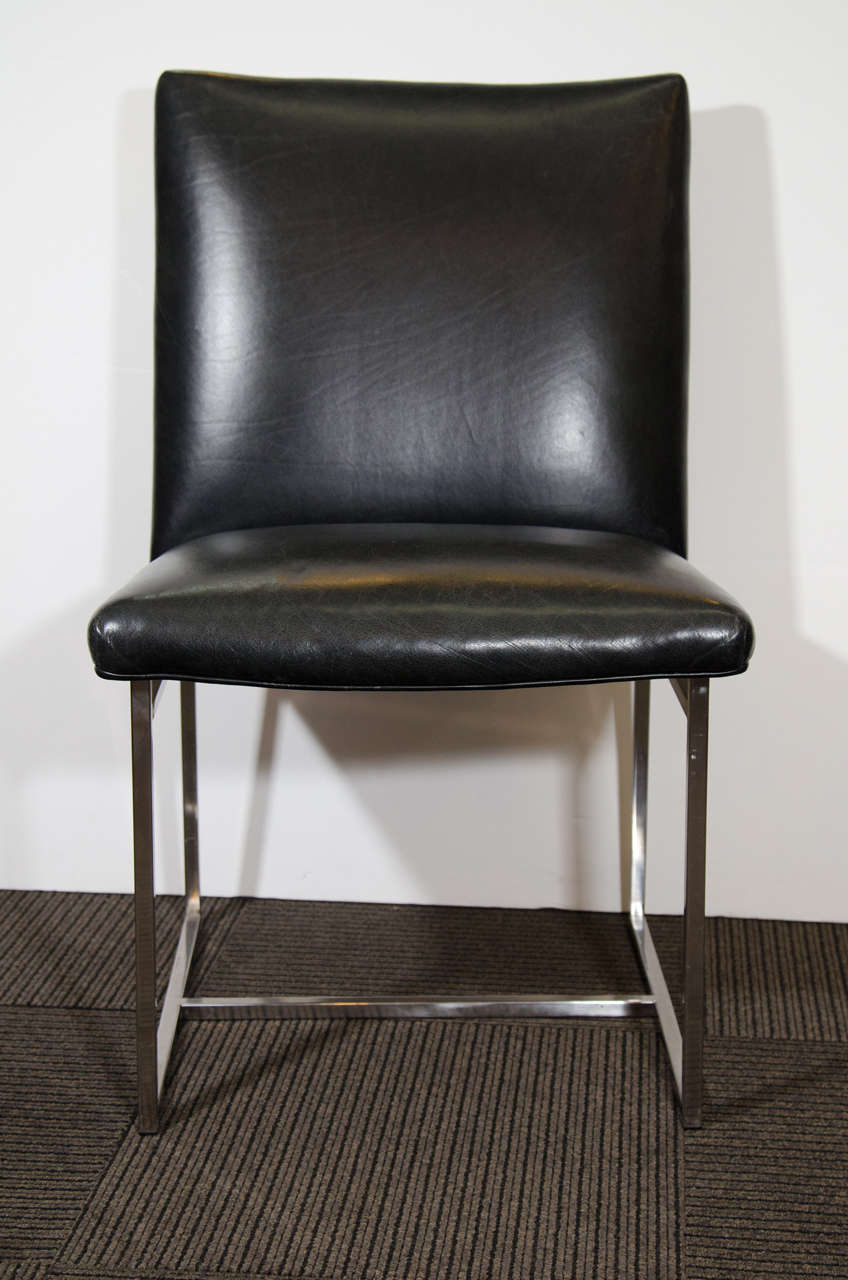 A vintage set of four charcoal leather and chrome Milo Baughman dining chairs.

Good vintage condition with age appropriate wear and patina. A few scuffs marks. Chairs sold as is. 