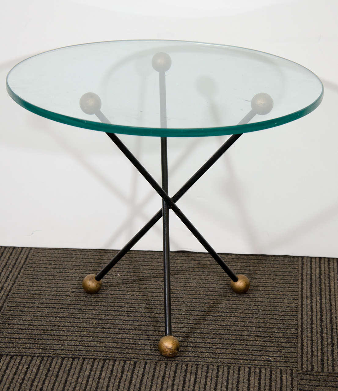 A vintage pair of end or side tables with glass tops and steel bases in the shape of Jacks by Tony Paul.