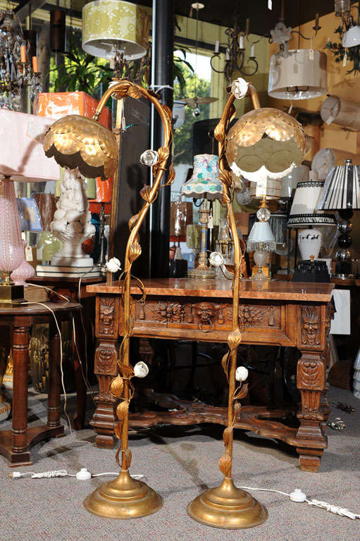 Whimsical (crazy) lotus blossom inspired floor lamps with brass and tole blossoms, leaves, and vines.  The shades are overlapping brass leaves with an ivory tole interior.