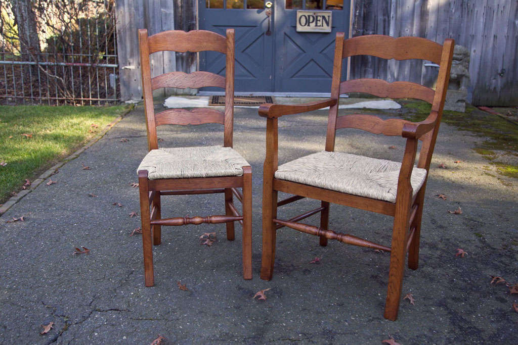 These chairs, constructed in sturdy oak, but finished in a fruitwood stain offer the best of both worlds: Handsome French country style and solid, substantial construction. The rush slip seats are a classic touch, but can be over upholstered for a