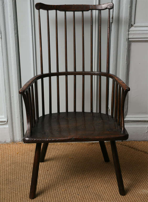 Unusual 18th Century comb back Windsor armchair, the shaped crest over nine shaved spindles, the bentwood arm over saddled seat with bent wood arch supports, standing on four spoke shaved legs, the whole with excellent color.  Most likely from the