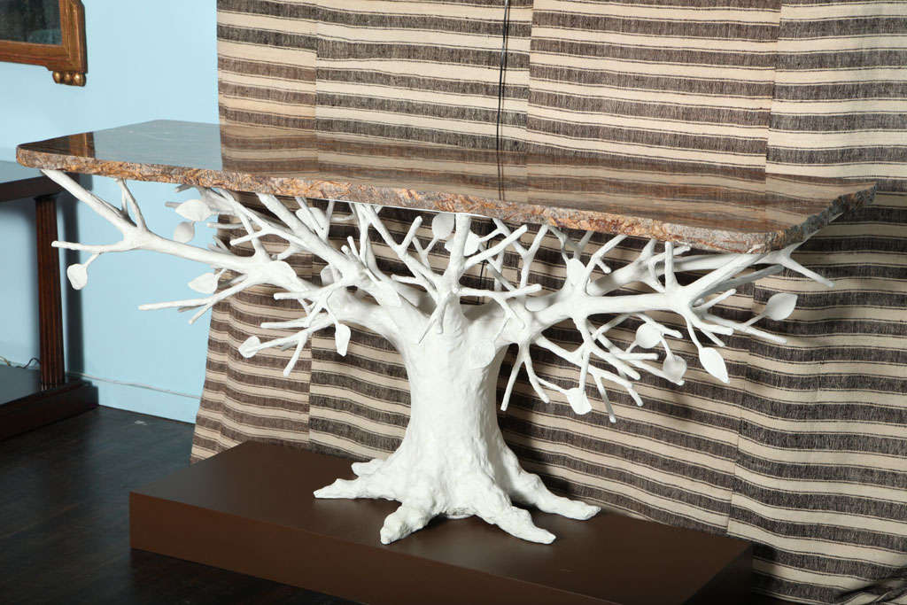 Dynamic, large-scale console table being made in an edition of 8. Base made of plaster over iron, in the form of a tree. Complete with roots, branches and leaves. Highly figured stone, slab top, with three free edge sides. (The brown pedestal