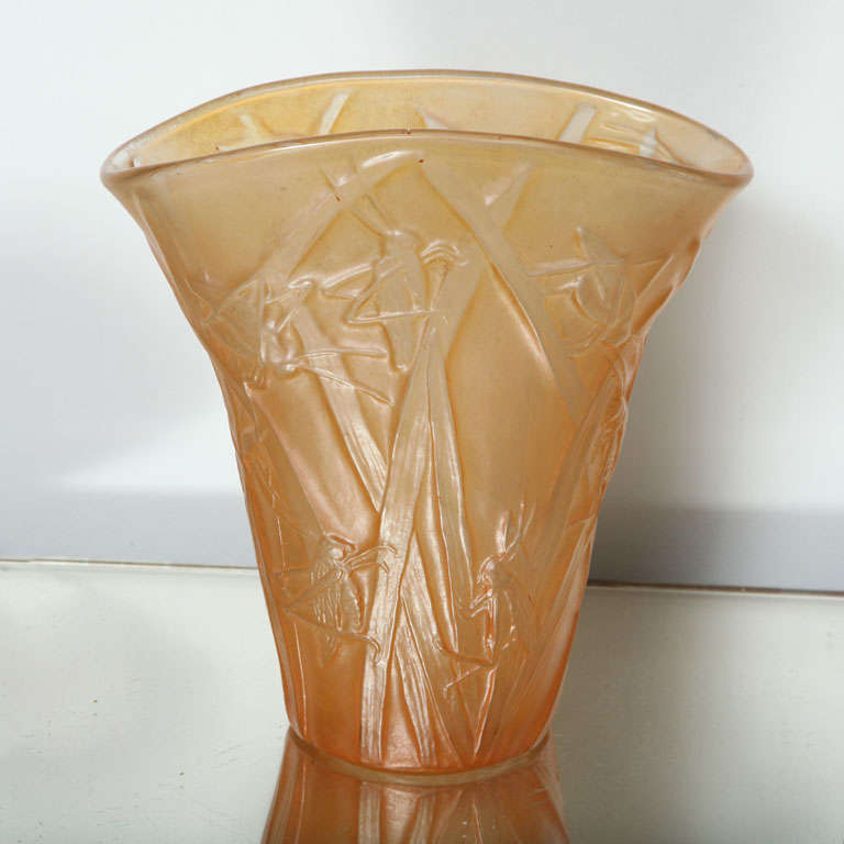 A great amber Phoenix Glass vase depicting grasshoppers on reeds.