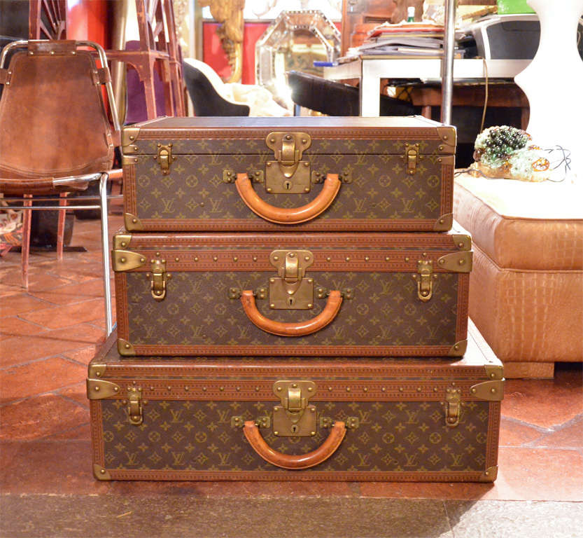 Amazing set of three antique suitcases by the legendary Louis Vuitton. Each case is outfitted to facilitate meticolous packing. One case is fitted with belts to keep clothing wrinkle-free, and two feature removable fitted trays for multi-layered