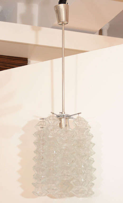 Exceptional glass pagoda form pendant chandelier suspended on a nickel frame by Kalmar.
Currently a pair is available.