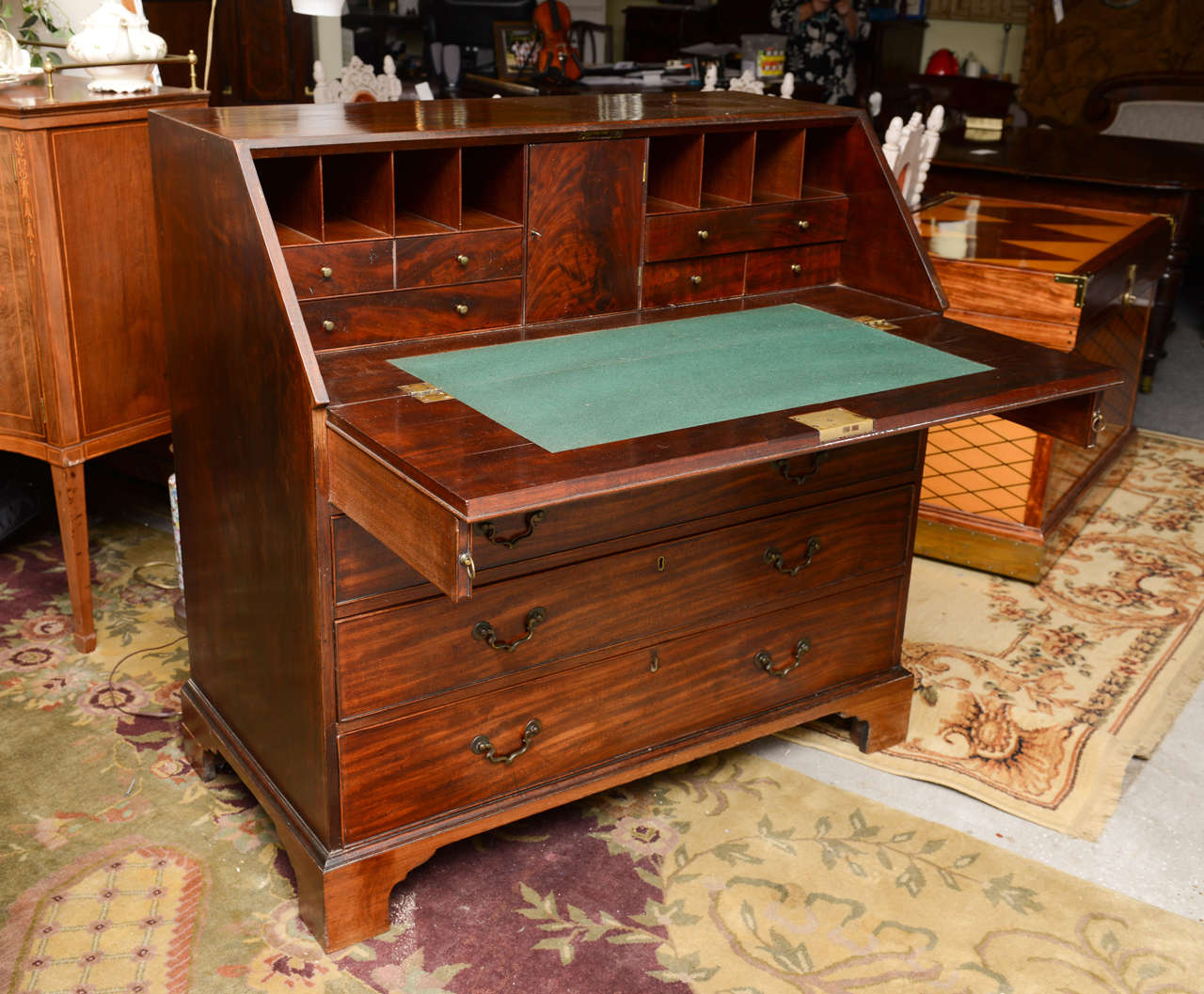 This is a superb large solid mahogany Bureau Writing Desk made in England circa 1860.
It sits on bracket feet, to the inside it has several drawers to the center it has a door with the original key to lock it.
The brass handles are all original as