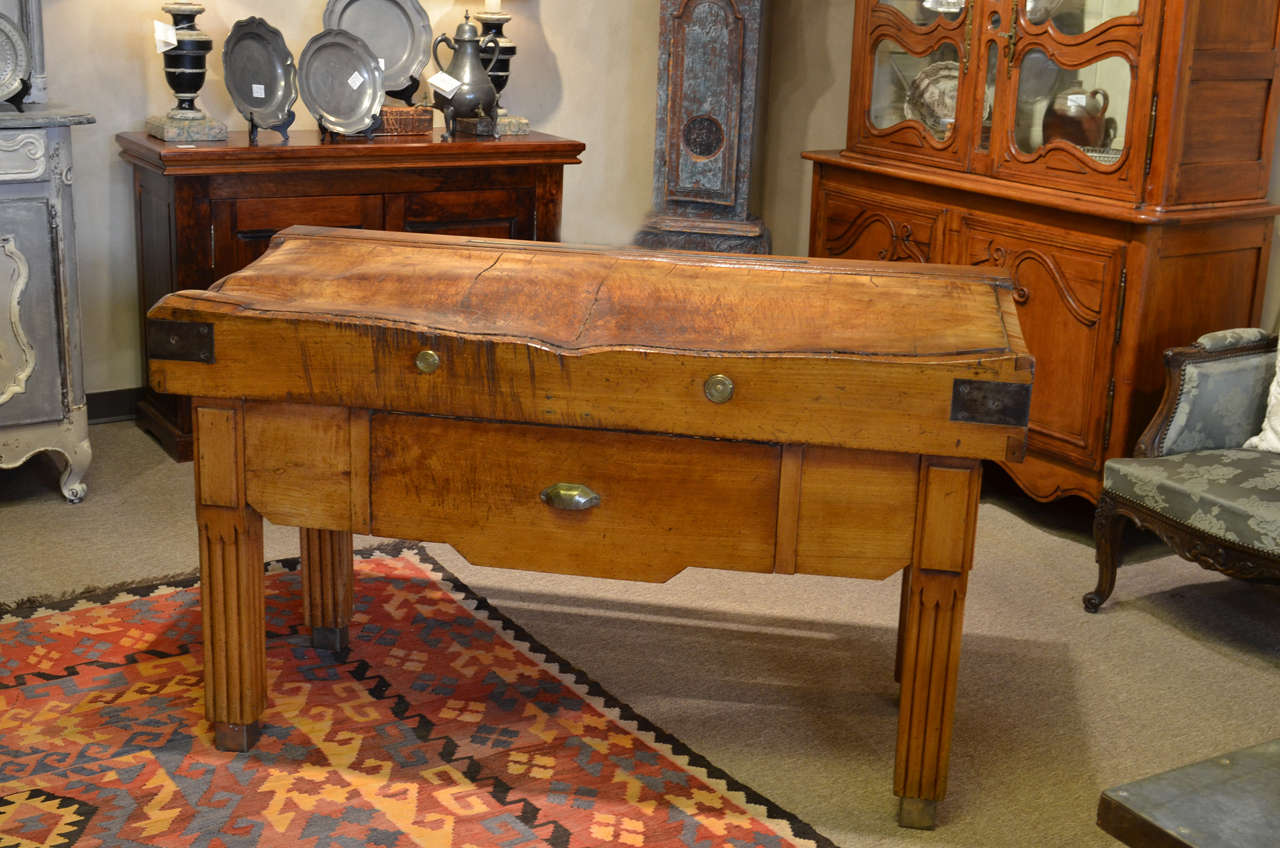 This is a very fine example of an  antique French butcher block.  The patina and the massiveness of the 