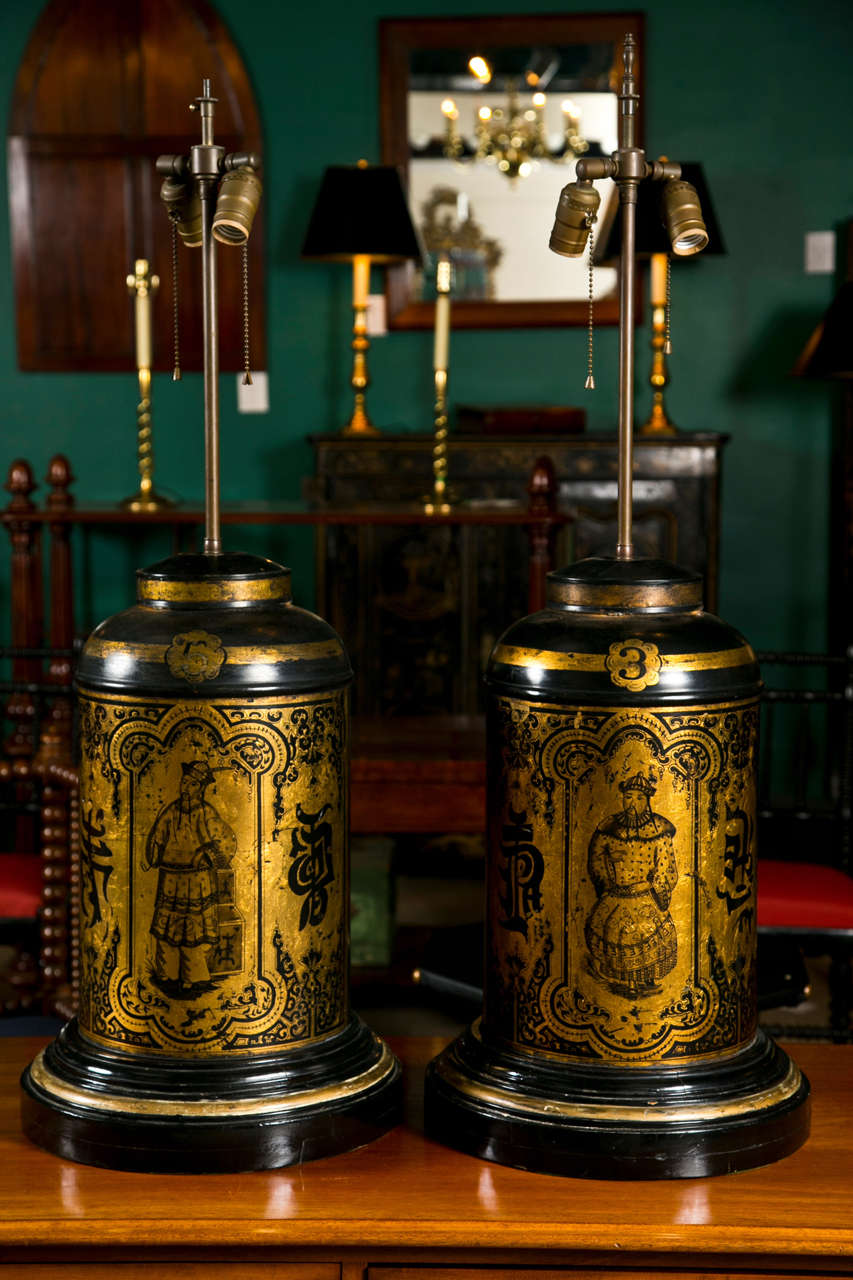 A pair of antique tole,gilt and painted oriental tea canisters now as lamps.