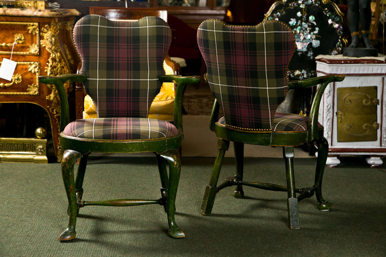 A wonderful set of four George II flaring chinoiserie arm chairs in beautiful upholstery.