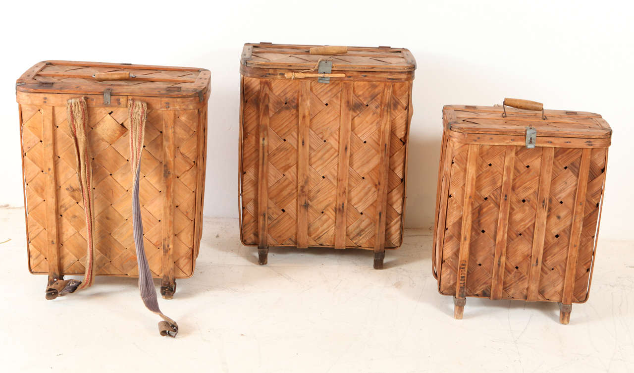 Vintage traveling backpacks with wood latticework and closing hardware.