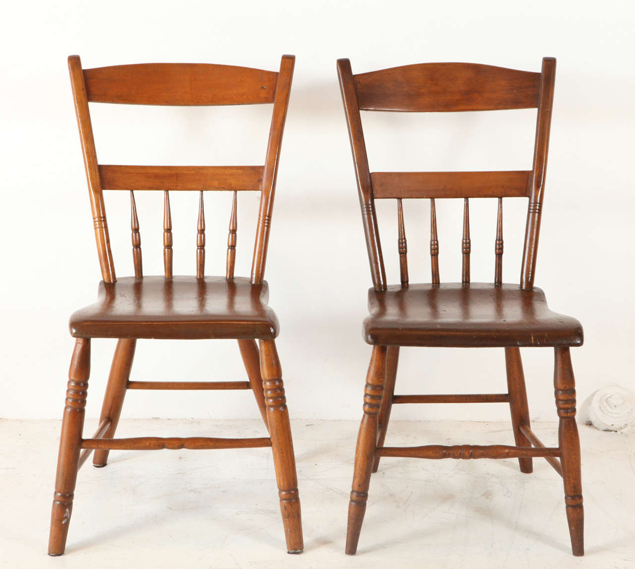 Charming American pine spindle back dining chairs. Note: there is a slight variation in the spindle detail.