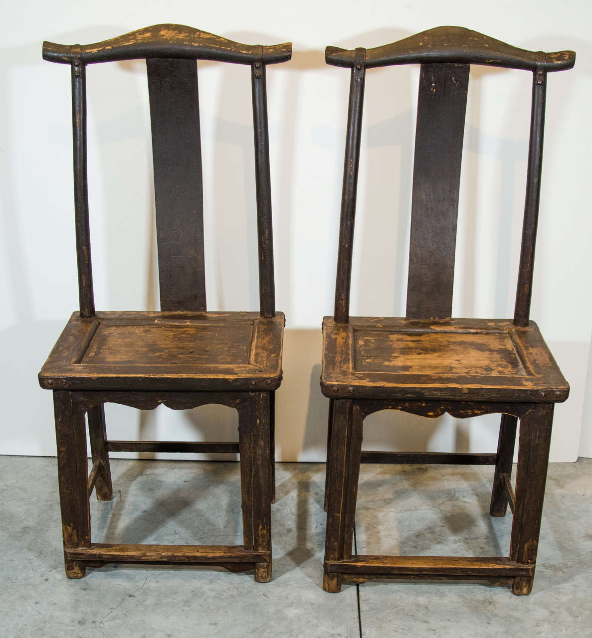 A pair of beautifully worn antique Chinese official's hat chairs with classic lines and original iron straps on back and seat. From Shanxi Province, circa 1880.
CH360.