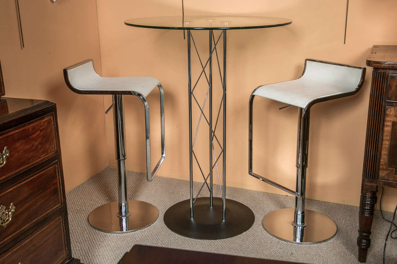 A very unique metal base bar table with glass top.
With a pair of metal base stool with leather seats.
Possibly Italian design.