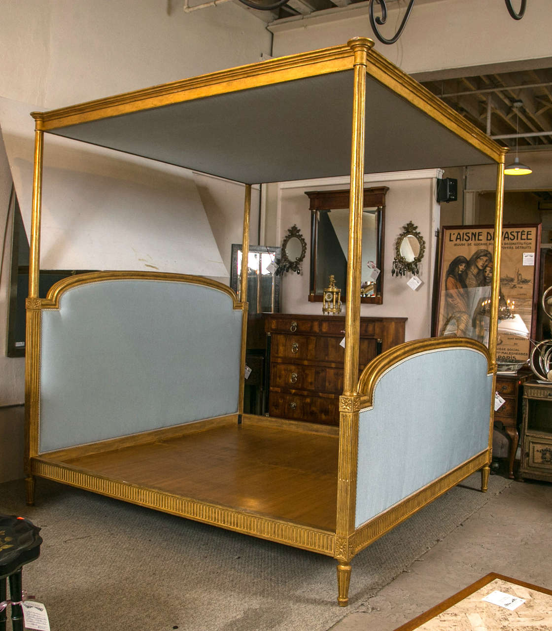 A French king-size canopy bed in giltwood Louis XVI fashion. This fine attributed Maison Jansen kings-sized bed is absolutely spectacular. The Louis XVI inspired look having a custom quaintly fine guiding. The overall finely distressed to have a