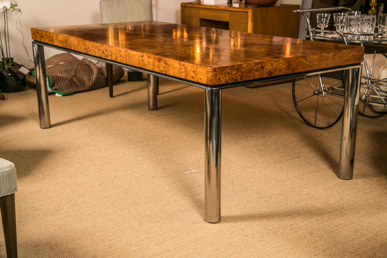 A contemporary burl wood and chrome dining table in the manner of Milo Baughman.