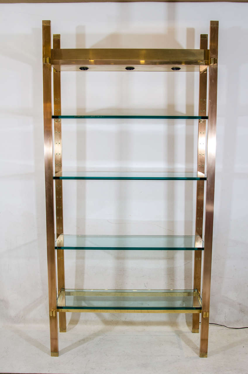 Exceptional mixed metal etagere in polished copper, brass and bronze. Very nicely detailed, with four substantial glass shelves illuminated from above designed by Paul M. Jones. Gorgeous! Please contact for location. 