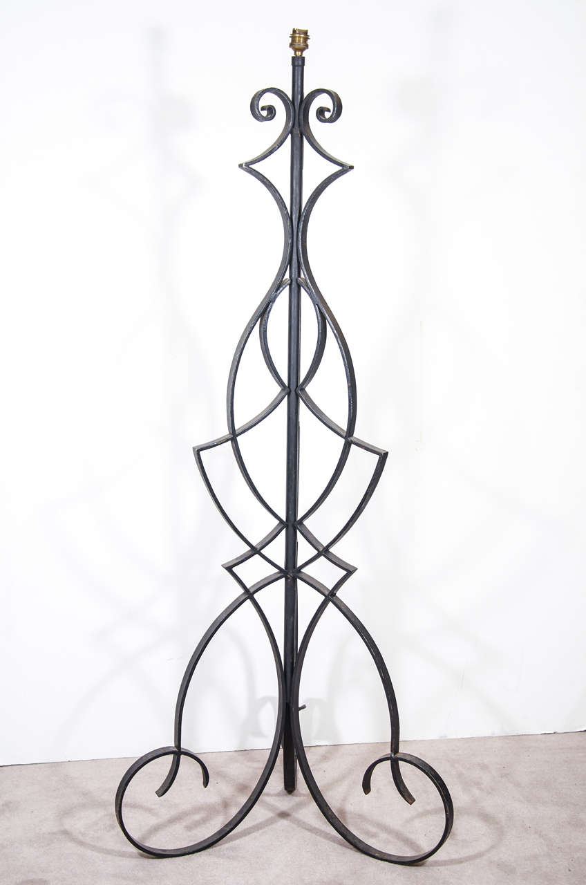 A vintage, large, ornate, Wrought Iron floor lamp painted black and attributed to Robert Merceris. European socket and wiring
