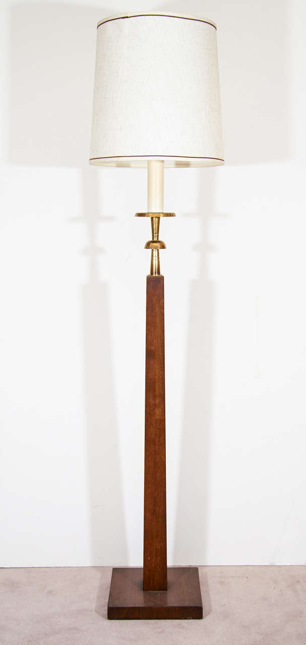 A pair of vintage floorlamps with wood bodies and bases, brass detailing and white shades. They are attributed to Tommi Parzinger.
