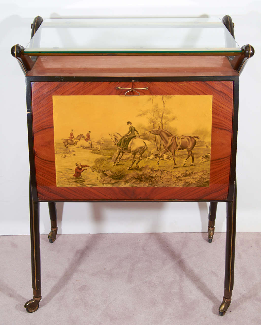 Illuminated Italian bar in wood with glass surface and brass details. There is an  Laminated Equestrian Scene on one side,Reminiscent Of Fornasetti and the interior is Mirrored with glass shelves that rest in Brass Holders.