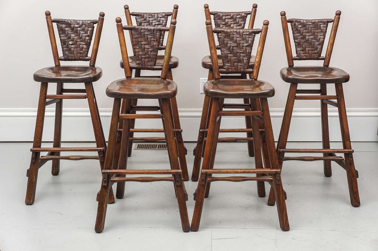 Six comfortable rustic bar or kitchen stools by Old Hickory, Indiana. The stools are structurally sound with the burned in the wood label.