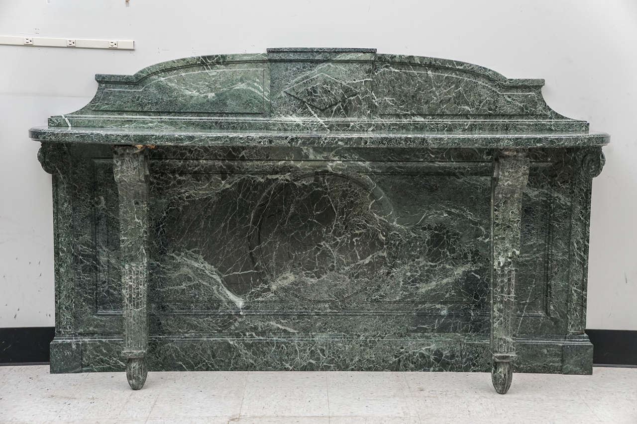This large console table made in France circa 1880 to 1900 is made entirely of a richly veined green marble. This was always an expensive and refined piece of furniture and would have graced either a major country home or a large and impressive