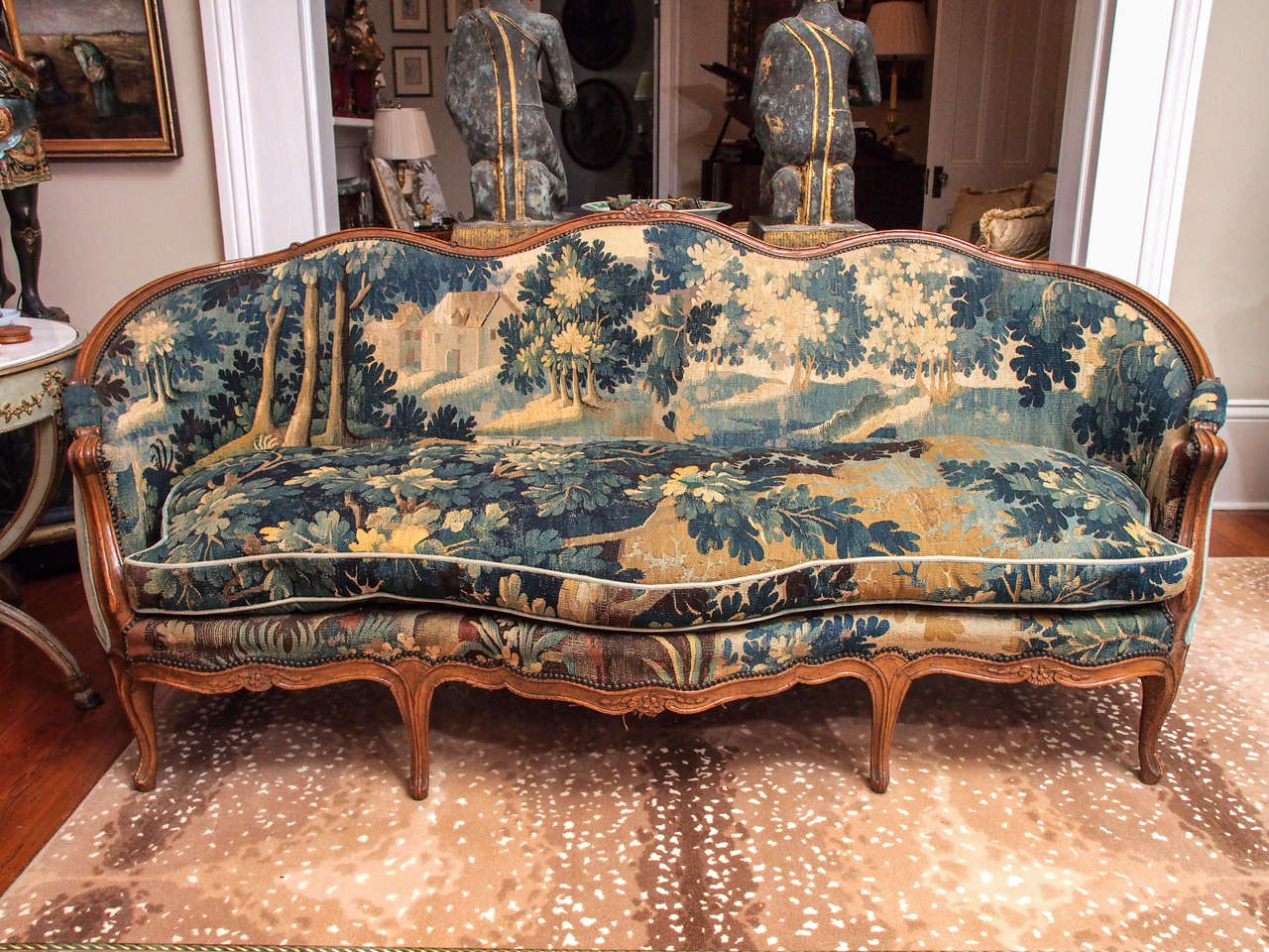 French walnut Louis XV canapé covered in 17th century tapestry fragments with loose cushion and velvet back.