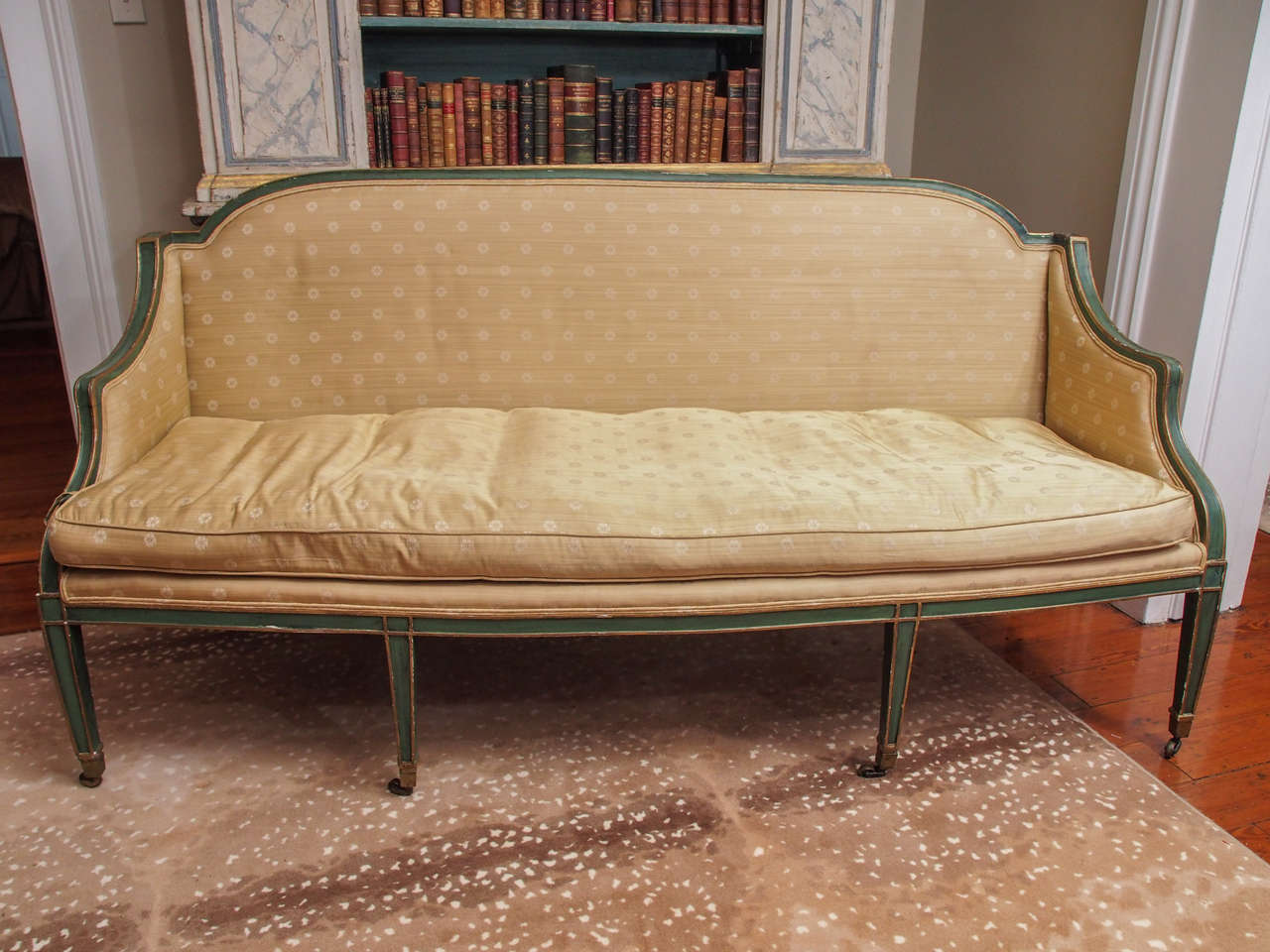 English painted and parcel-gilt sofa in the Sheraton taste.