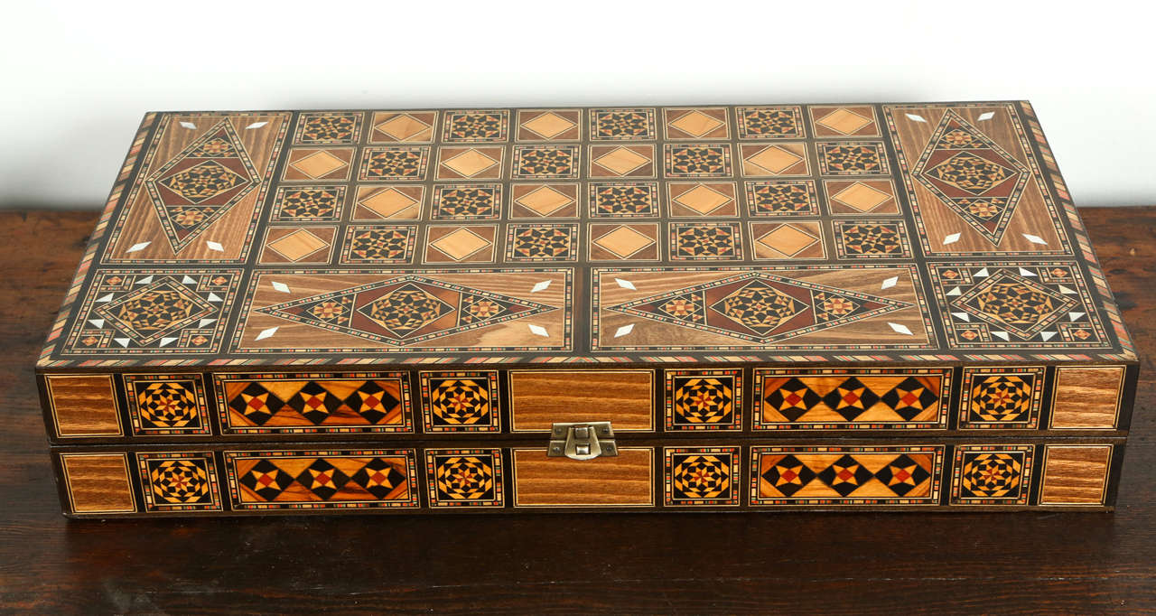 Syrian inlaid mosaic backgammon game.
Great inlaid micro mosaic box with backgammon game with all the wooden dice and pieces.
Size: Closed: 3