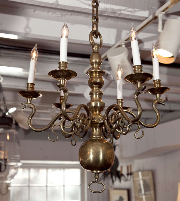 Clearly, the serpent arms are an indication that this is an Irish chandelier. Dating to the late 19th century, this chandelier has hollow arms and was perhaps lit using gas. It has since been converted to electrical wiring. Each arm is beautifully