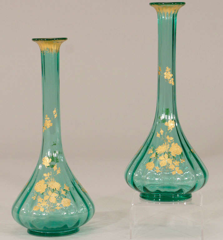 This is a lovely pair of teal blue 19th c. hand blown crystal vases with optic ribbing, well balanced foot and long and elegant lines. They are very well matched and further embellished on the front and back, with hand painted raised paste gold