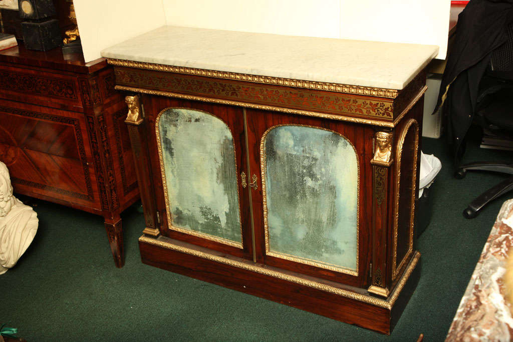 Very fine quality English  Regency brass inlaid ,parcel gilt  and wood marble top two door  cabinet with mirrored doors.