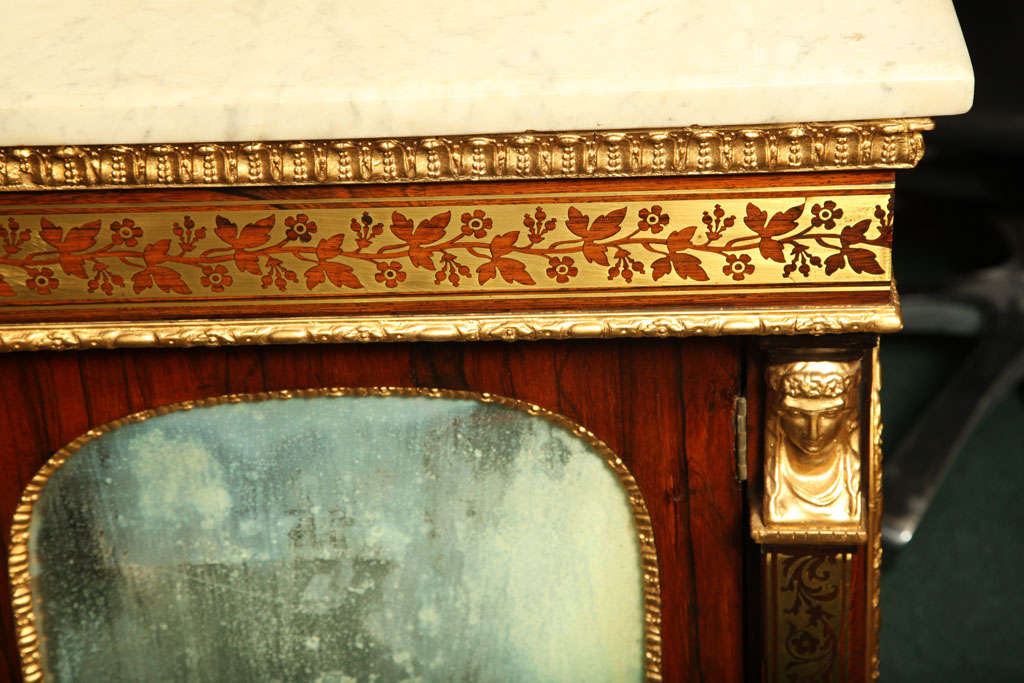 Gilt Regency brass inlaid marble top cabinet.