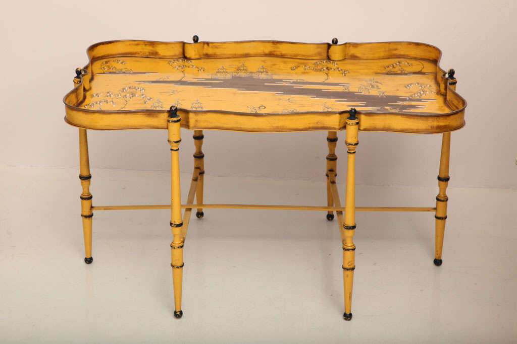 Yellow tole-ware low table with chinoiserie decorate try top that lifts off a folding base.
Italian, c. 1950s