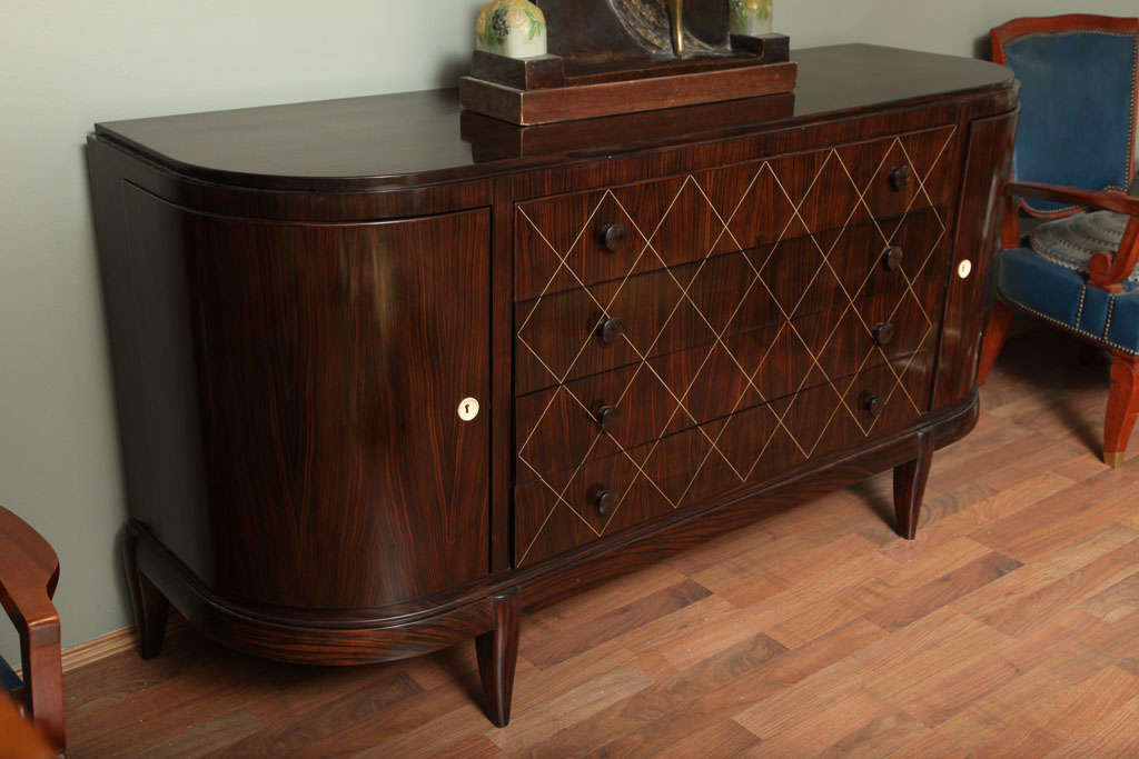 Travail Francais, 1930s.
Macassar ebony four drawers sideboard with rosewood lateral doors interiors. Measures: H 36.2” x L 70” x D 22”.